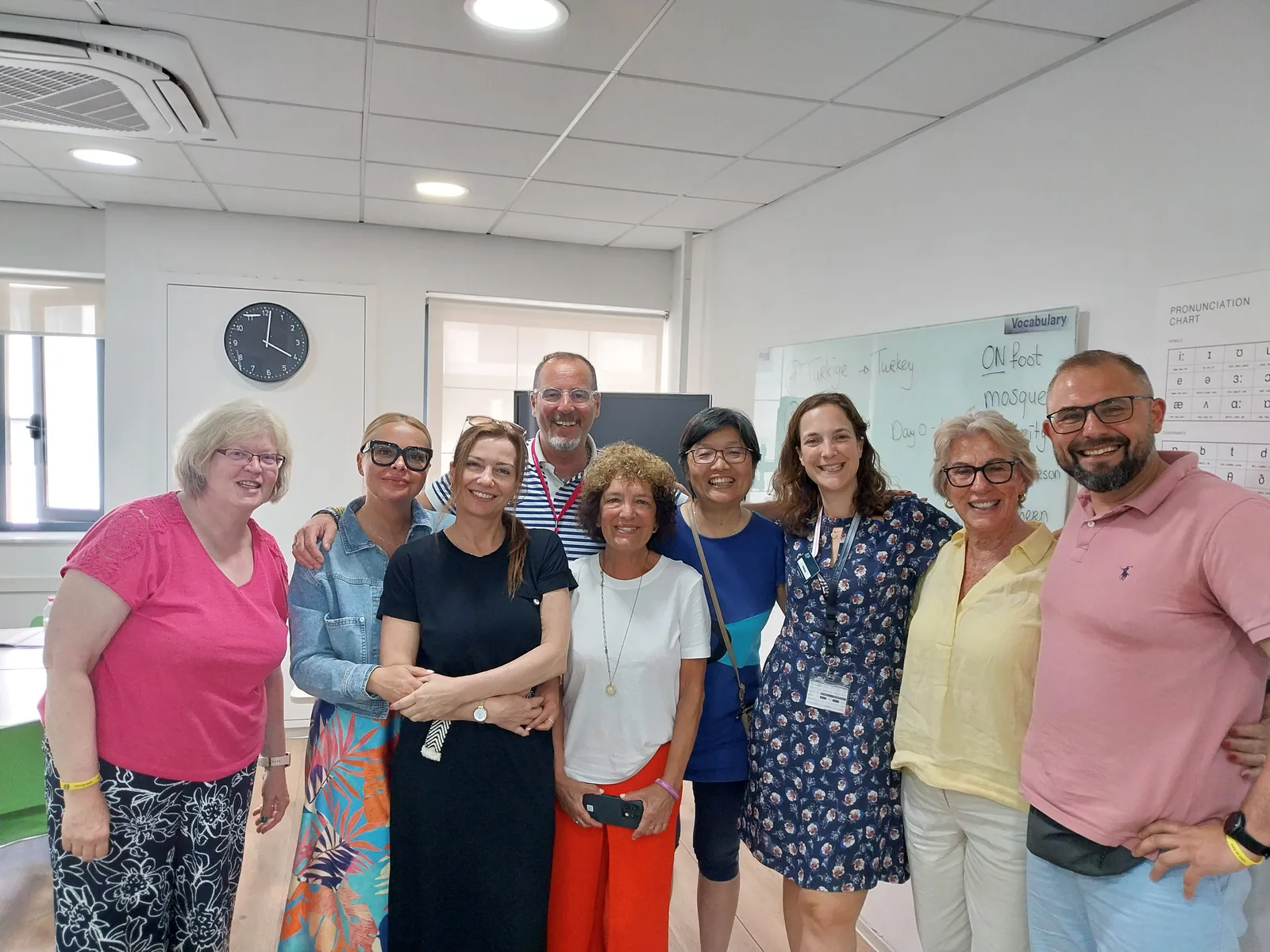 A group of teachers smiling together in the staff room